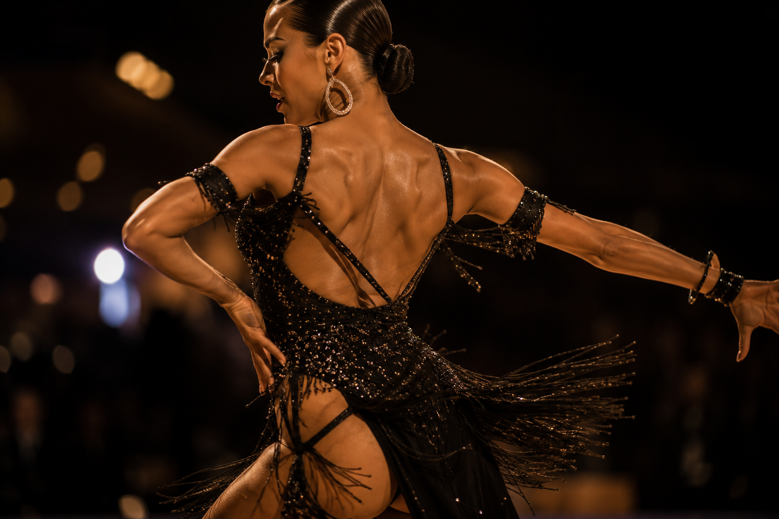 Latin dancer performing in an expressive competition dress with a strong, energetic silhouette.